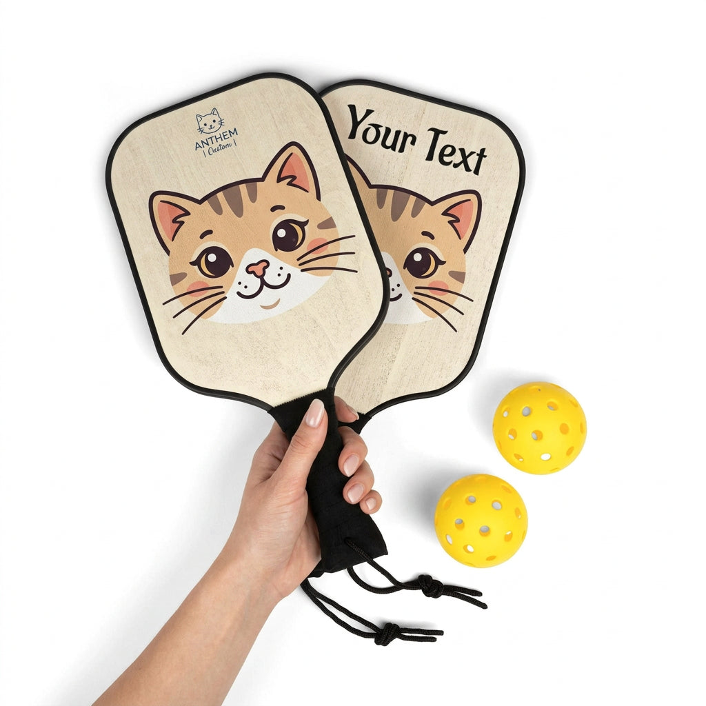 Two customizable wooden pickleball paddles with black handles and three yellow pickleballs on a white background.